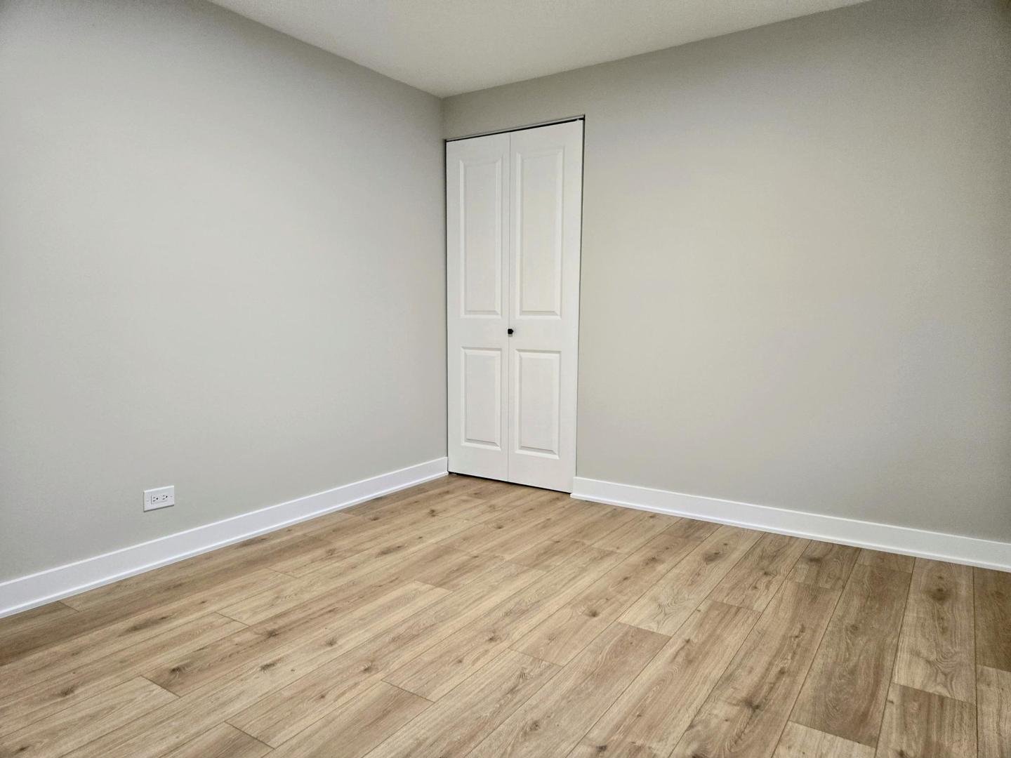 16536 Wolcott Avenue Markham, IL 60428 - Photo 10 of 18 a view of an empty room with wooden floor