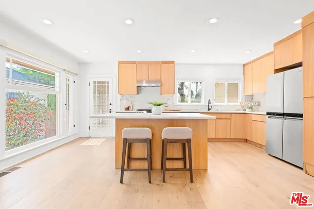 a kitchen with a stove a sink and a refrigerator