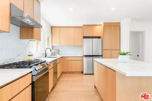 a kitchen with a refrigerator and a sink