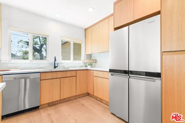 a kitchen with stainless steel appliances granite countertop a sink stove and cabinets