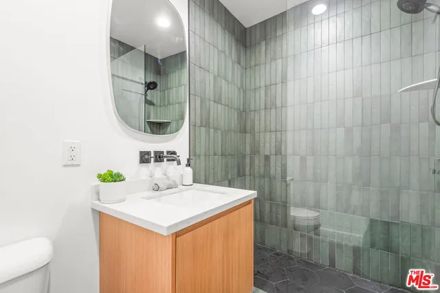 a living room with furniture and a large mirror