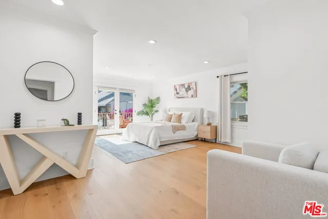 a spacious bedroom with a bed and a large window