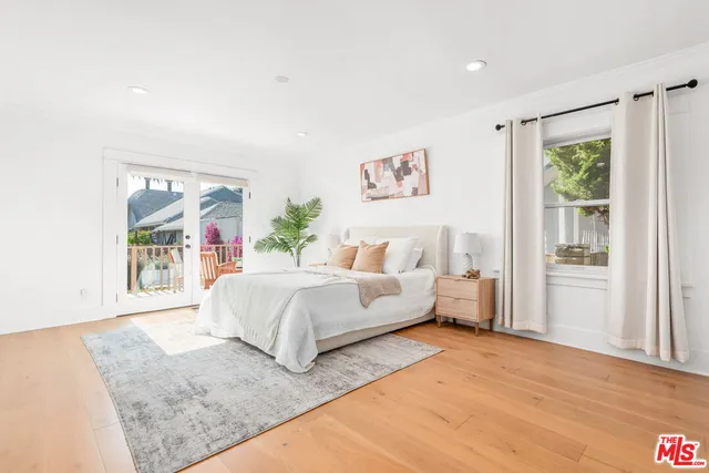 a living room with a large bed and a large window