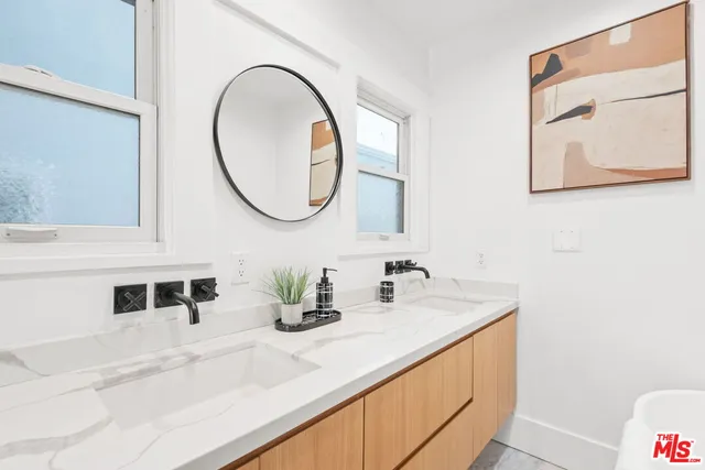 a white tub sitting next to a white wall