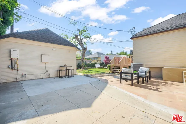 a view of a house with backyard and sitting area