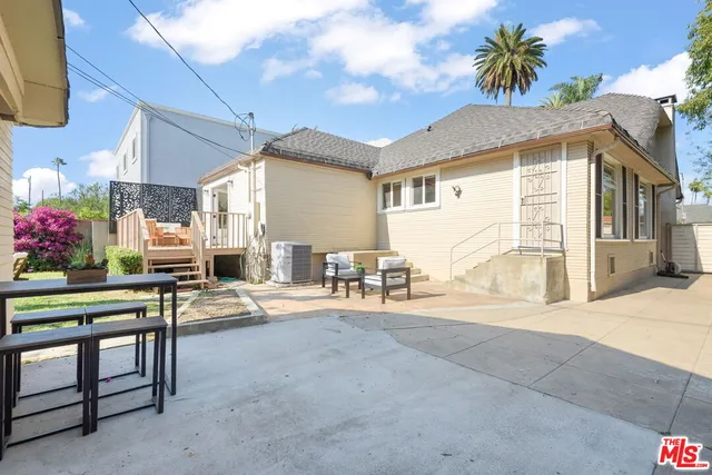 a view of a chair and table in the garden