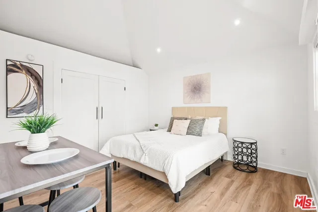 a bedroom with a bed and a table