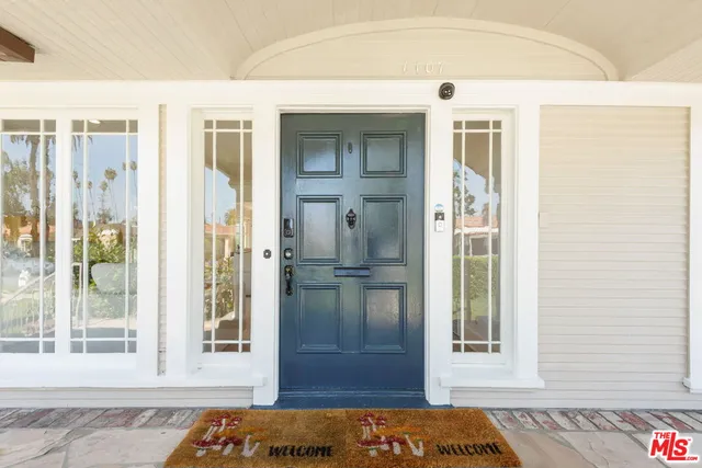 a living room with fireplace furniture and a large window