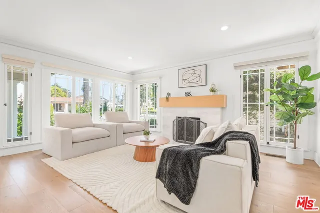 a large white kitchen with a sink and cabinets