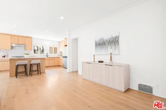 a living room with kitchen island furniture and a kitchen view