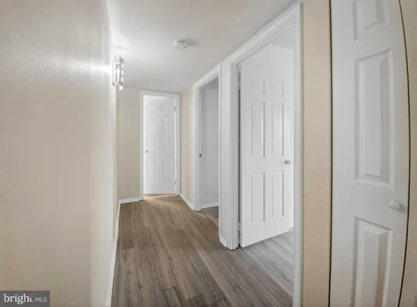 a view of an empty room and wooden floor