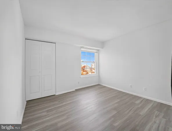 a view of an empty room and wooden floor