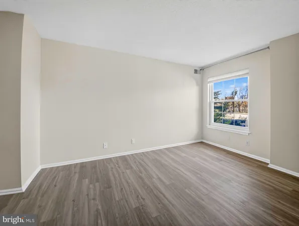a view of an empty room and wooden floor