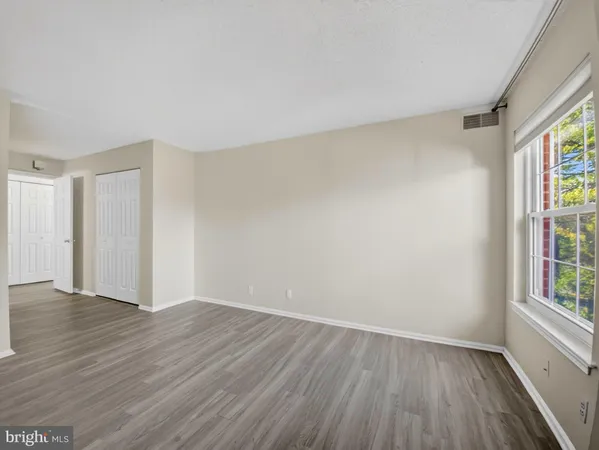 a view of a hallway to rooms