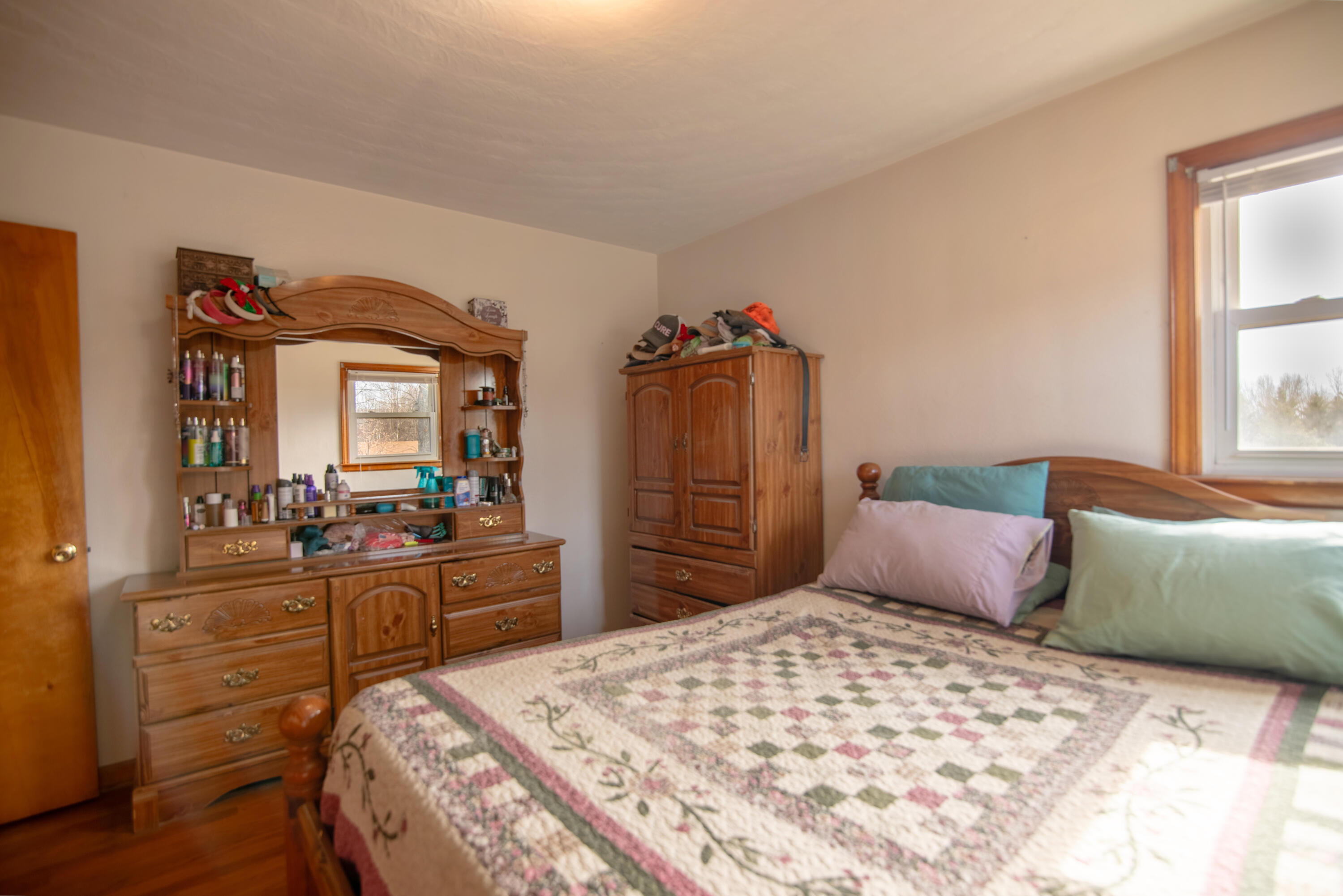 1065 Mountain Valley Road Vinton, VA 24179 - Photo 13 of 20 a bedroom with a bed and wooden floor