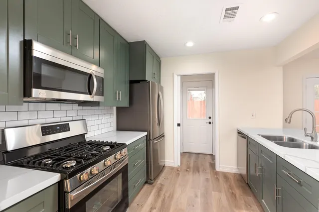 a kitchen with a sink appliances and cabinets