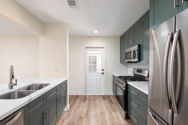a kitchen with microwave stove and cabinets