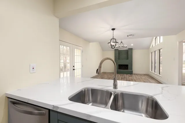 a view of a room with wooden floor and a ceiling fan