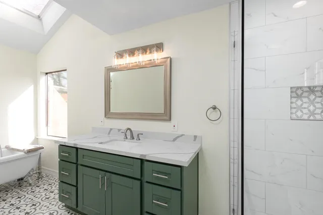 a white bath tub sitting in a bathroom next to a window