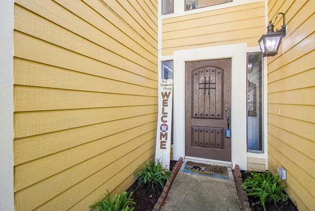 a view of staircase with lots of frames on wall