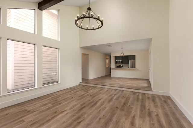 a view of empty room with wooden floor and fireplace