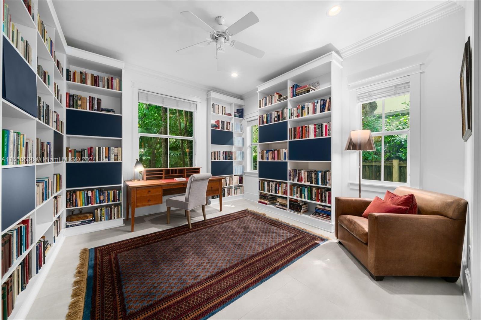 4050 Battersea Road Coconut Grove, FL 33133 - Photo 11 of 40 a living room with furniture and a book shelf