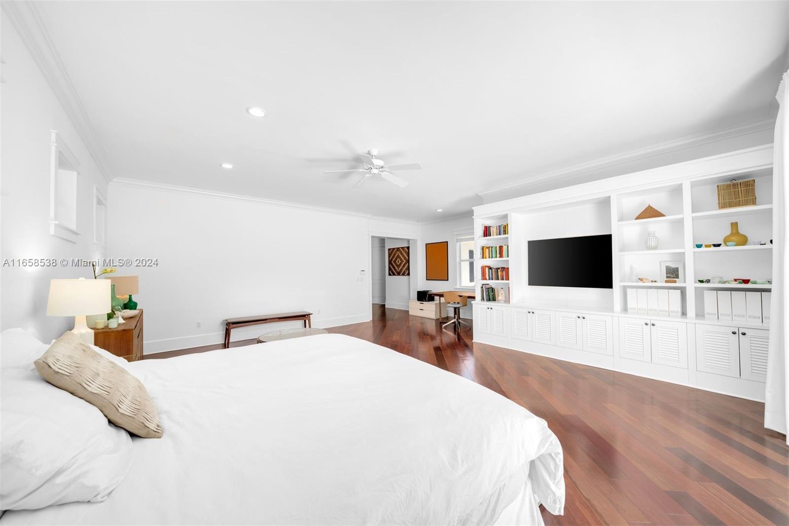 4050 Battersea Road Coconut Grove, FL 33133 - Photo 13 of 40 a bedroom with a bed a television and wooden floor
