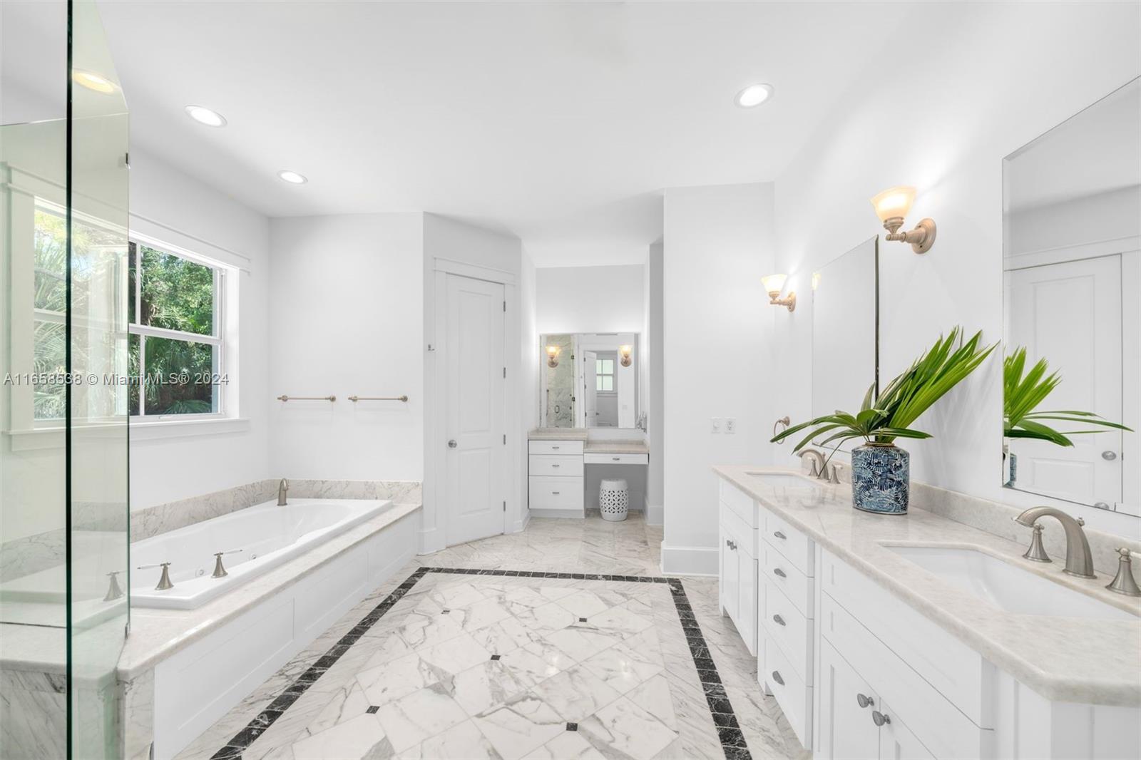 4050 Battersea Road Coconut Grove, FL 33133 - Photo 15 of 40 a bathroom with a tub sink and mirror