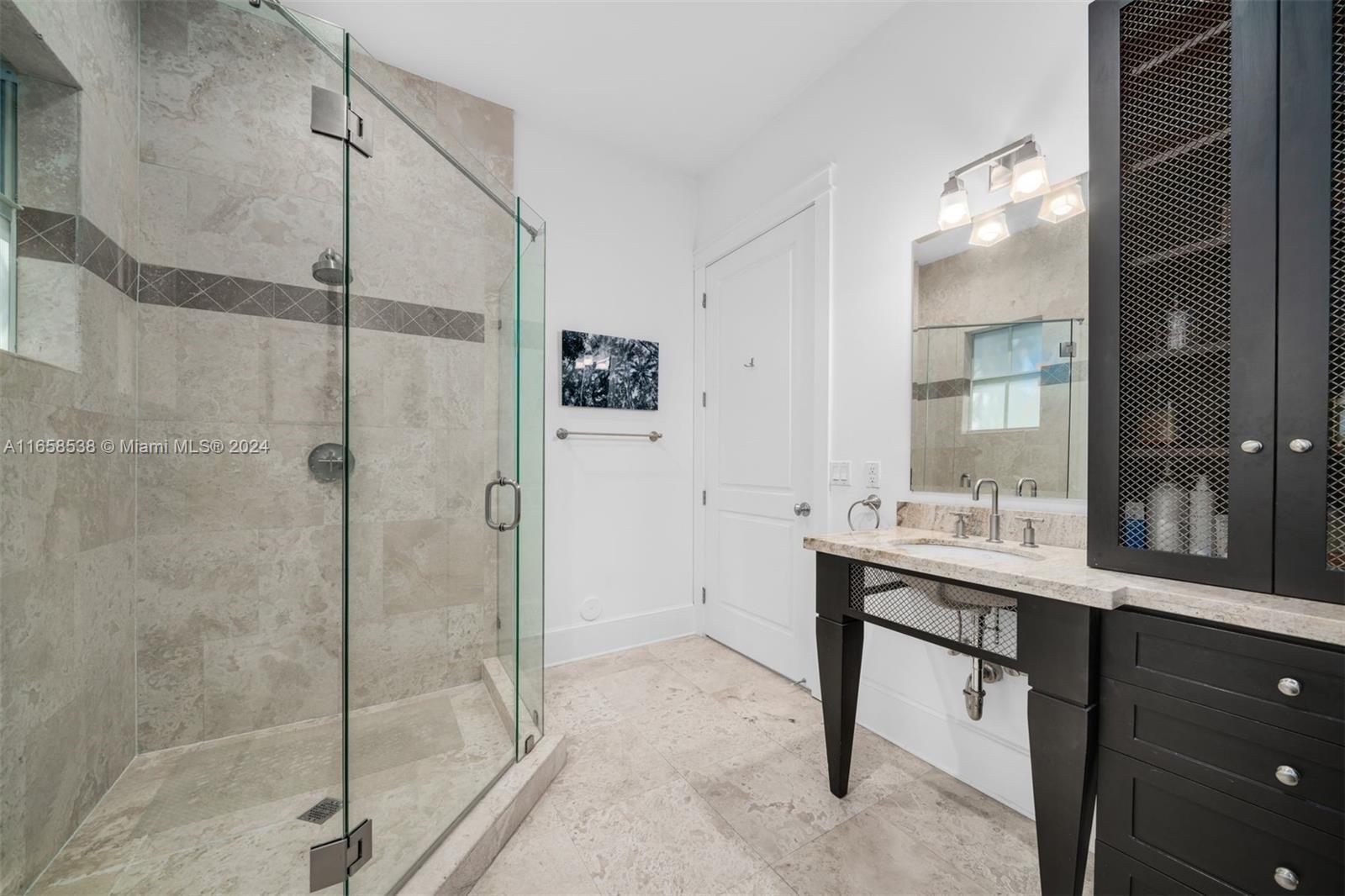 4050 Battersea Road Coconut Grove, FL 33133 - Photo 18 of 40 a bathroom with a shower sink and mirror