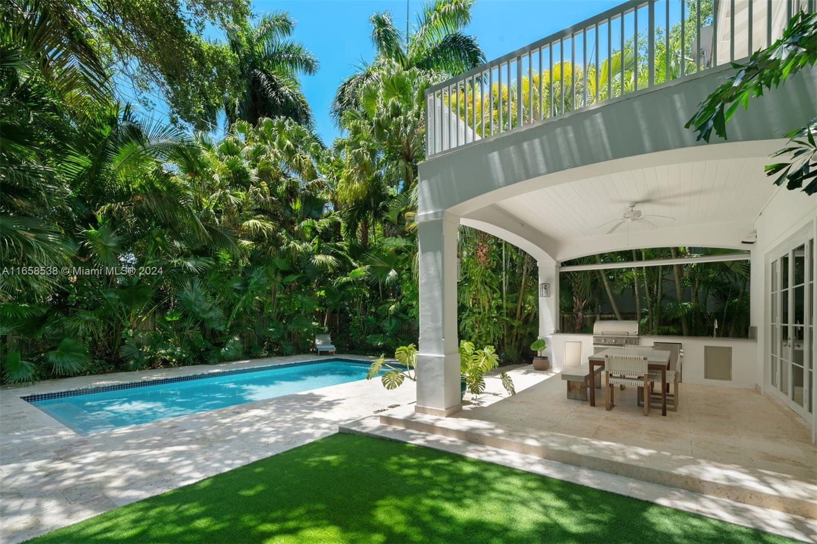 4050 Battersea Road Coconut Grove, FL 33133 - Photo 24 of 40 a view of a patio with table and chairs potted plants and large tree