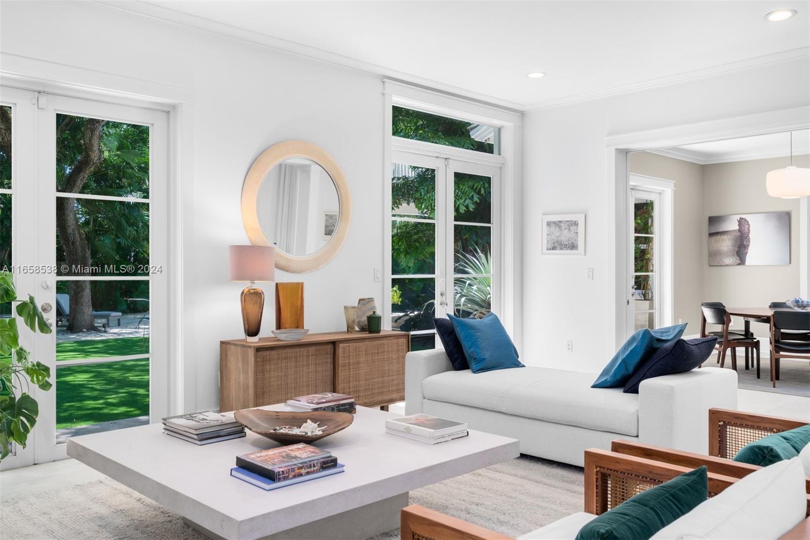 4050 Battersea Road Coconut Grove, FL 33133 - Photo 29 of 40 a living room with furniture a window and a fireplace