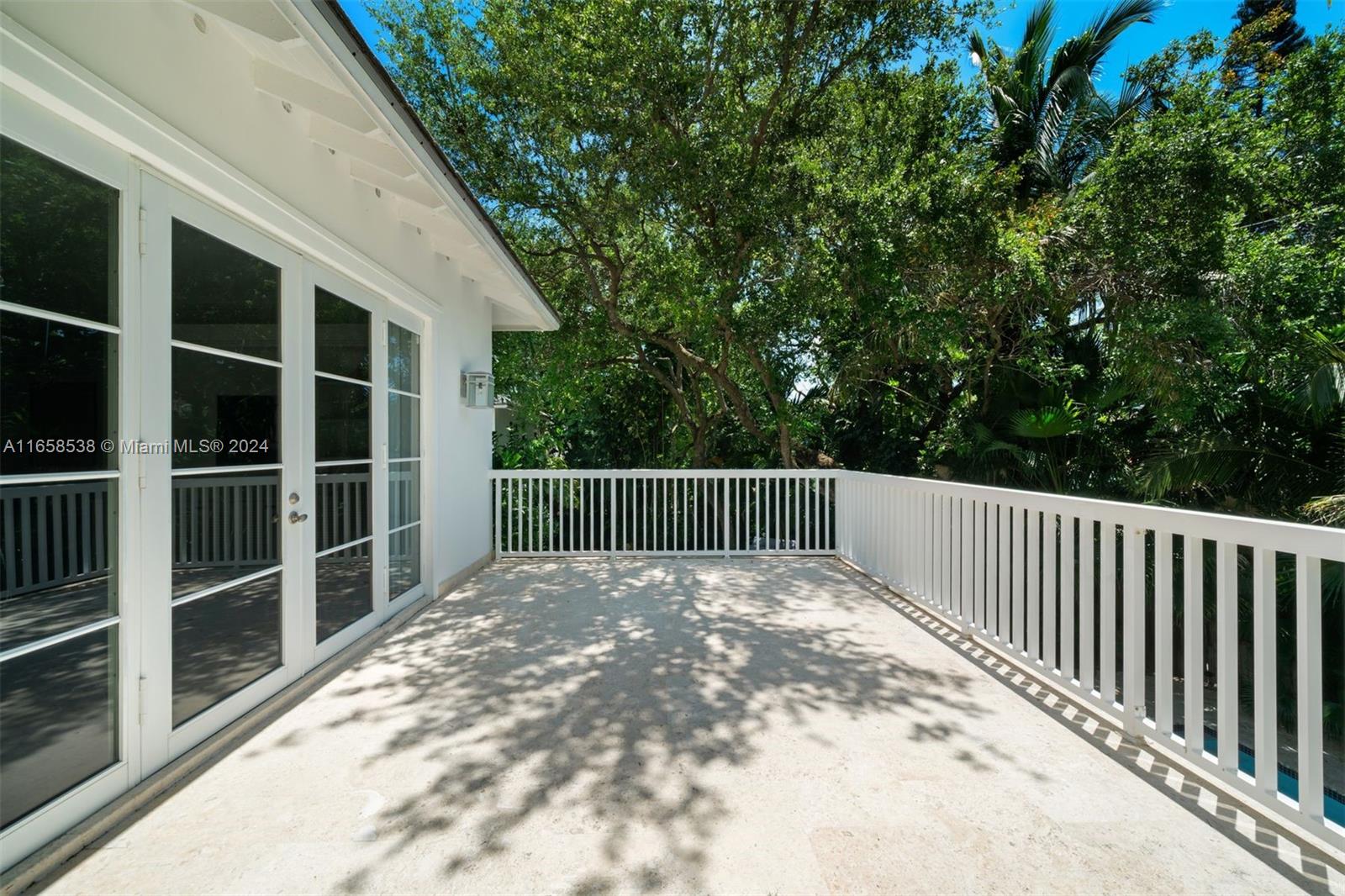 4050 Battersea Road Coconut Grove, FL 33133 - Photo 34 of 40 a view of backyard with deck and wooden floor