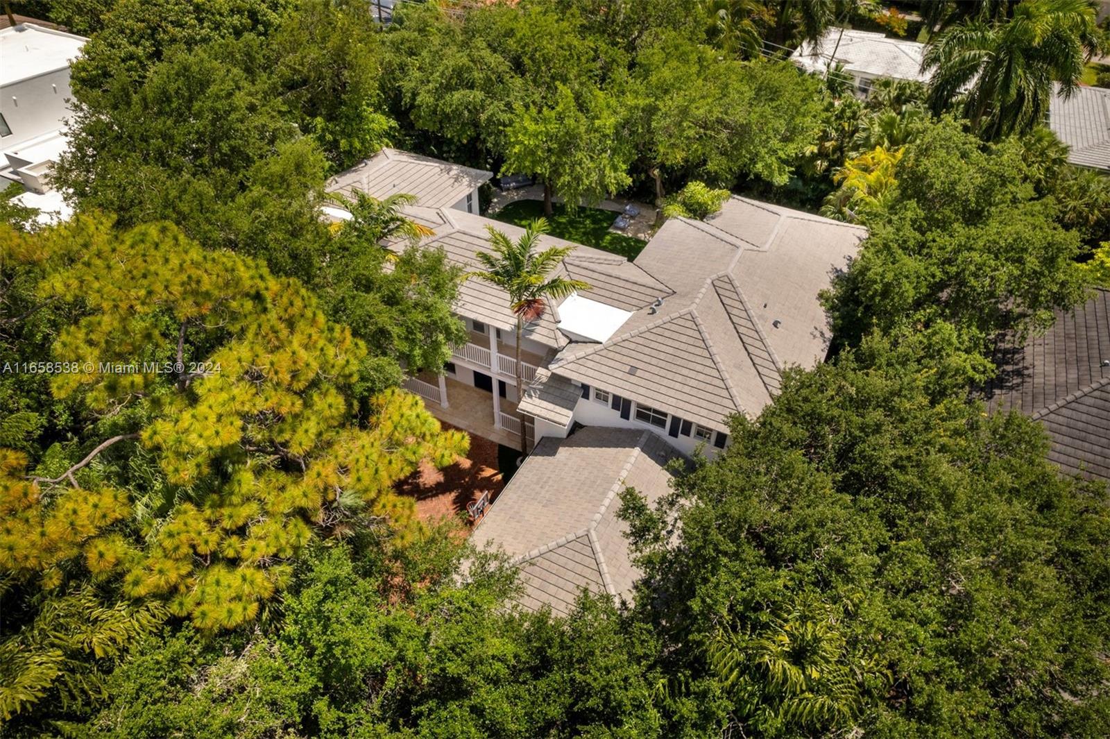 4050 Battersea Road Coconut Grove, FL 33133 - Photo 38 of 40 an aerial view of a house with a yard and covered with trees