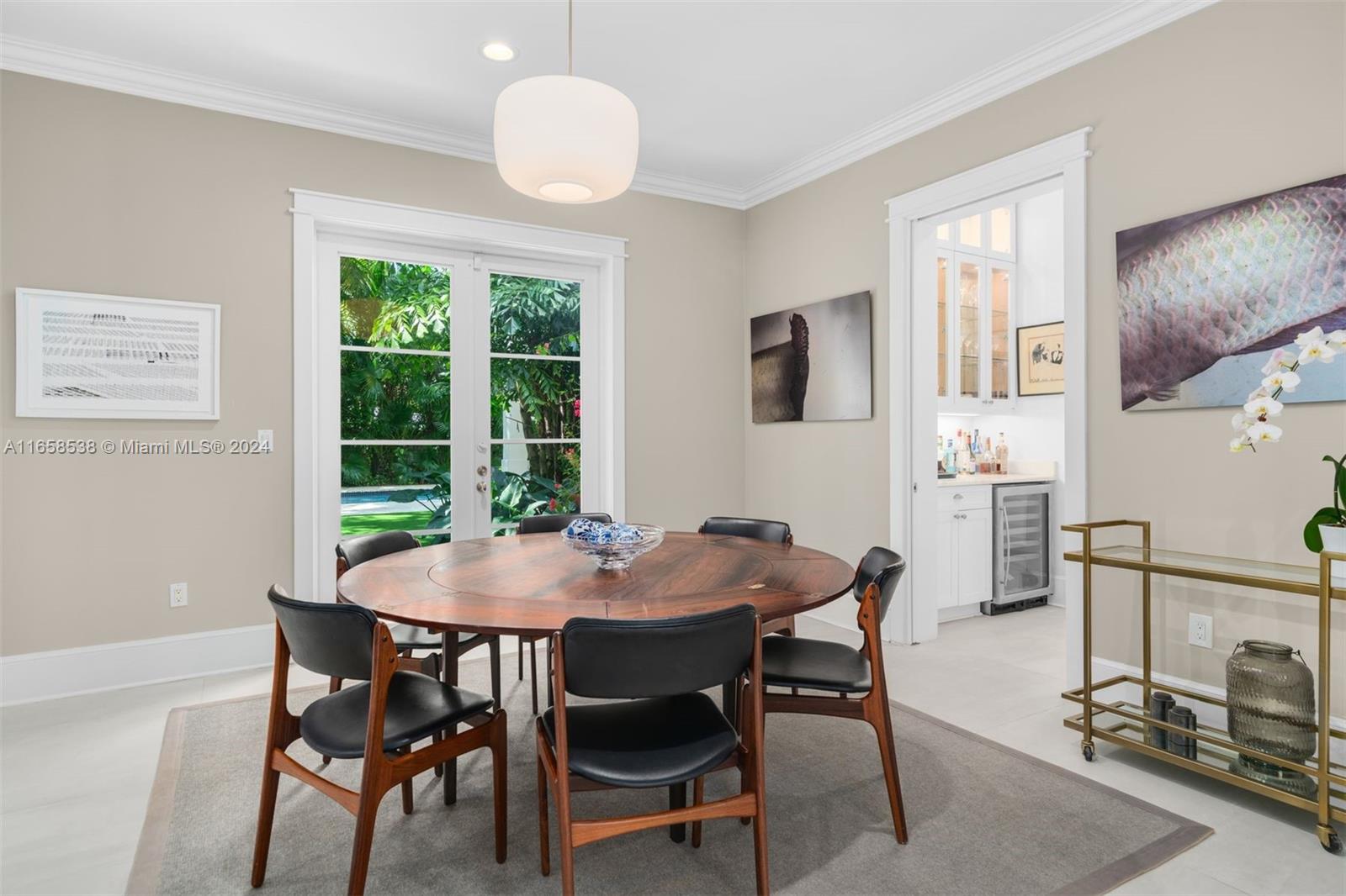 4050 Battersea Road Coconut Grove, FL 33133 - Photo 5 of 40 a view of a dining room with furniture and a window