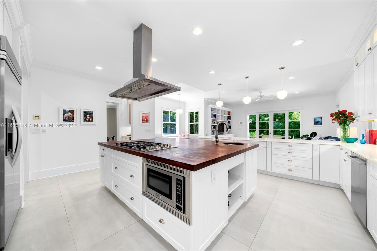 4050 Battersea Road Coconut Grove, FL 33133 - Photo 6 of 40 a kitchen with stainless steel appliances granite countertop a stove and a sink