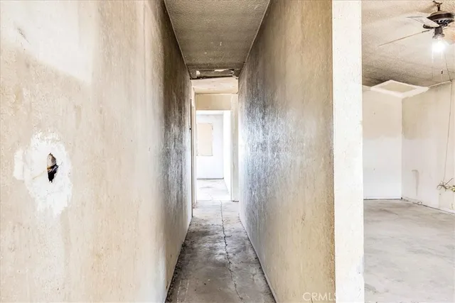 an empty room with a yellow door and a window