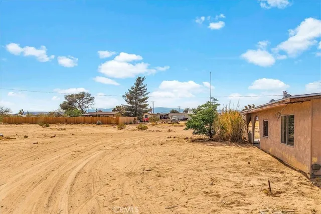 a front view of house with yard and ocean view