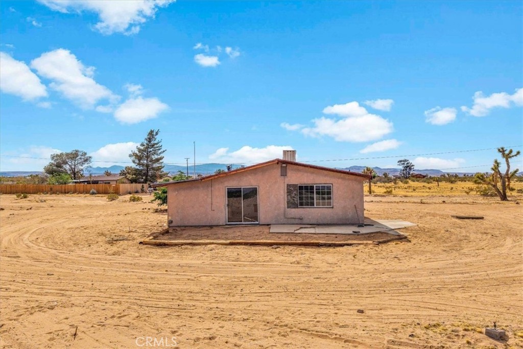 59724 Stearman Road Landers, CA 92285 - Photo 32 of 38 a front view of house with yard and ocean view