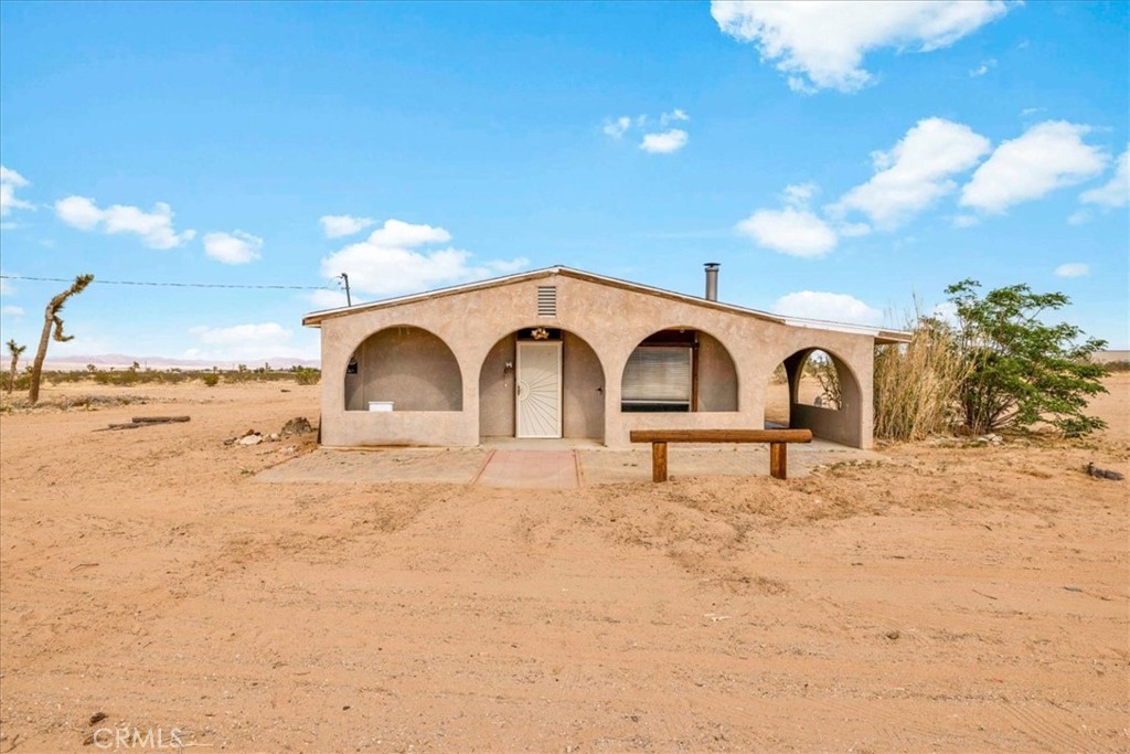 59724 Stearman Road Landers, CA 92285 - Photo 38 of 38 a white building with a yard