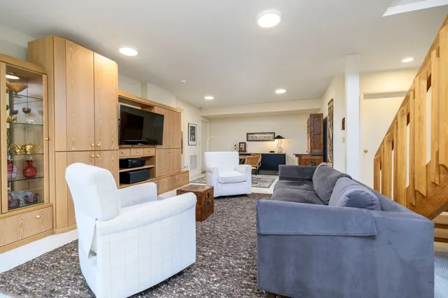 a living room with fireplace furniture and a flat screen tv