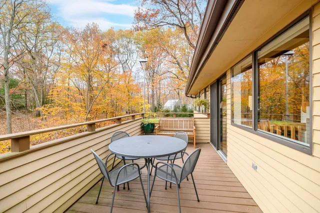 a view of a balcony with table and chairs