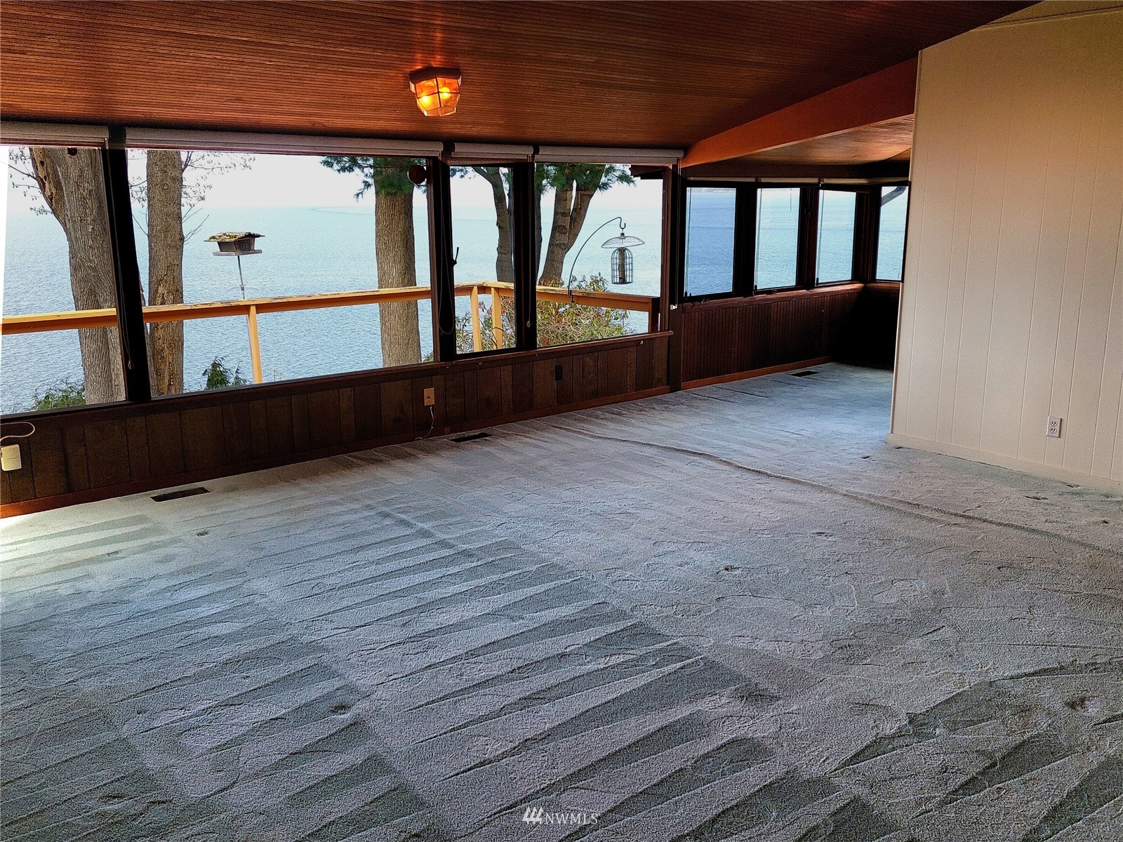 9205 Olympic View Drive Edmonds, WA 98020 - Photo 15 of 25 an empty room with wooden floor and windows