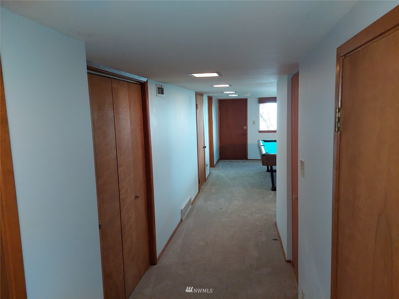 9205 Olympic View Drive Edmonds, WA 98020 - Photo 22 of 25 a view of a hallway with wooden shelves