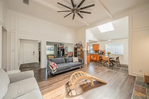 a living room with furniture and kitchen view