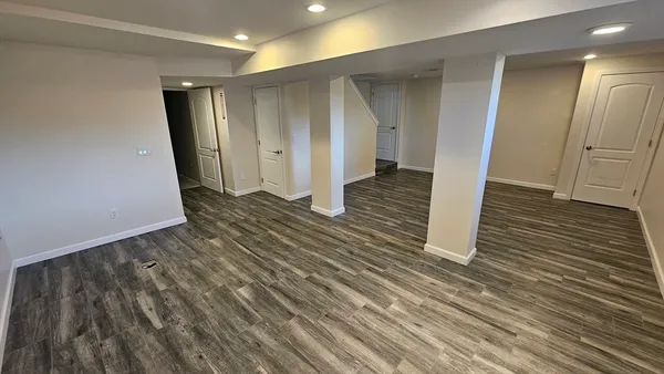 a view of a hallway with wooden floor
