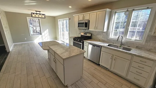 a kitchen with a sink stove and wooden cabinets
