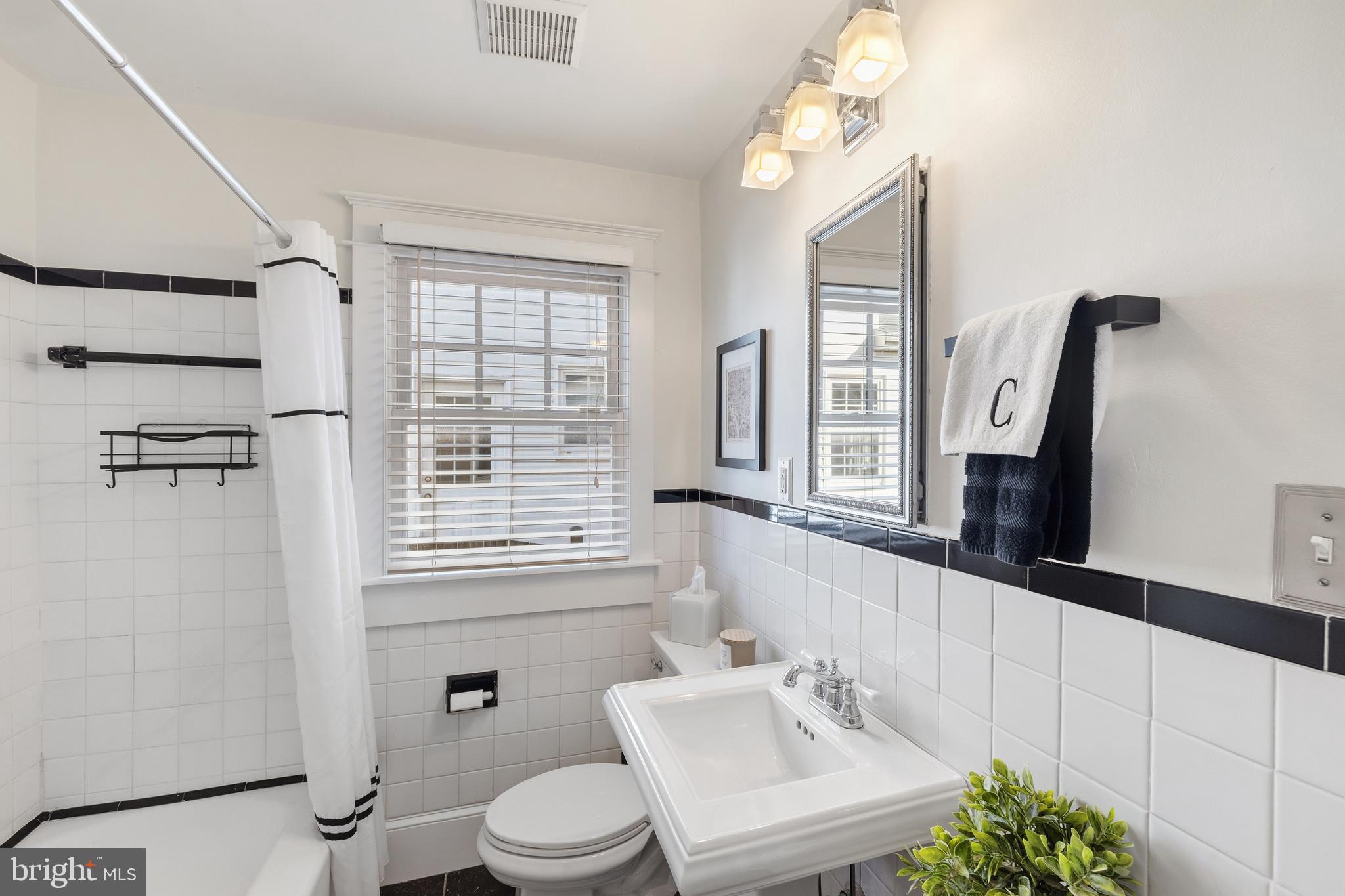 304 Locust Avenue Annapolis, MD 21401 - Photo 13 of 58 a bathroom with a sink a toilet and a mirror