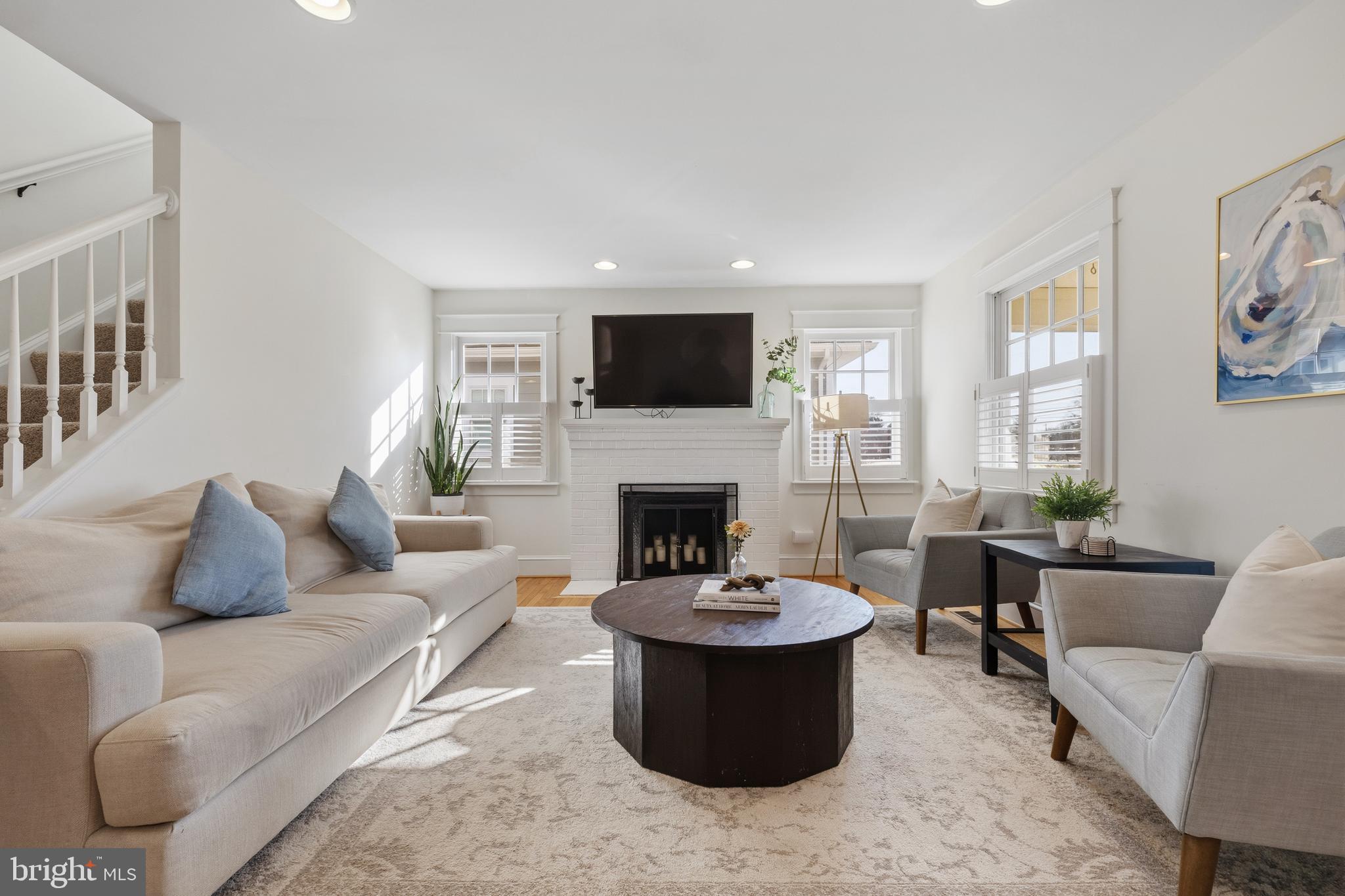 304 Locust Avenue Annapolis, MD 21401 - Photo 3 of 58 a living room with furniture a fireplace and a flat screen tv