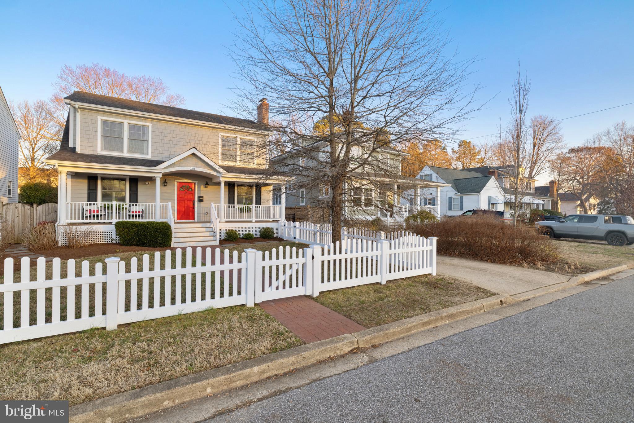 304 Locust Avenue Annapolis, MD 21401 - Photo 50 of 58 a view of a brick house with a small yard and large trees