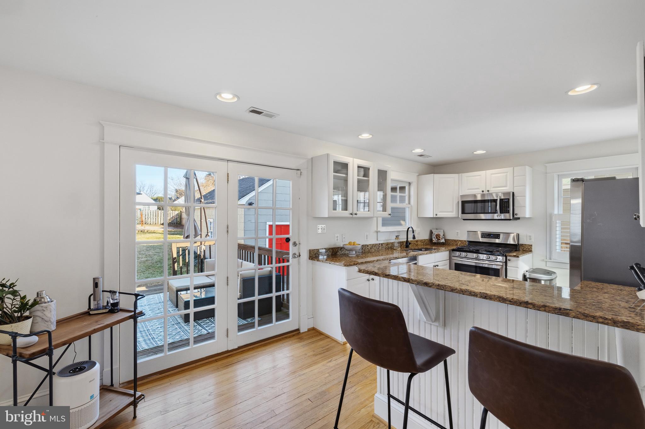 304 Locust Avenue Annapolis, MD 21401 - Photo 5 of 58 a kitchen with stainless steel appliances granite countertop a stove top oven a sink dishwasher and a refrigerator with wooden floor